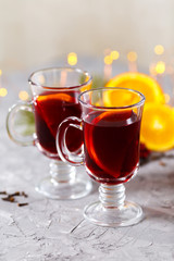 Obraz na płótnie Canvas mulled red wine with spices and orange on dark background. warming drink