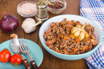 Red rice, risotto, pilaf with chicken and vegetables, garlic