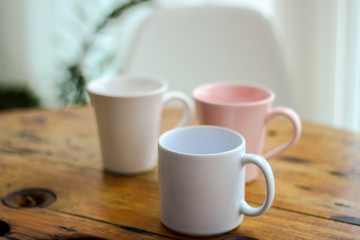 Fototapeta na wymiar white mugs cups of coffee on wooden table