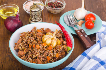 Red rice, risotto, pilaf with chicken and vegetables, garlic