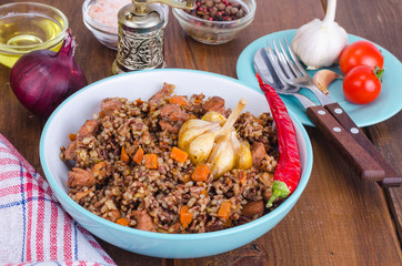 Red rice, risotto, pilaf with chicken and vegetables, garlic