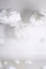 Artificial Cloud float in sky hang with sling over white background, studio lighting with color gel