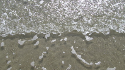 Ocean wave pulling back from the beach