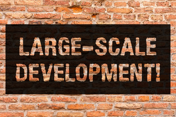 Fototapeta premium Writing note showing Large Scale Development. Business photo showcasing Develop on an extensive basis grow up a lot Brick Wall art like Graffiti motivational call written on the wall