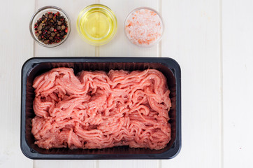 Minced meat in black plastic container