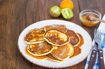 fried pancakes with sugar on plate to Shrovetide