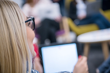 blonde businesswoman using digital tablet