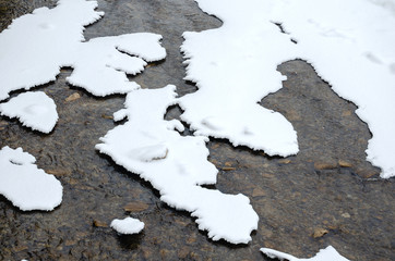 High angle view of montain river  partially covered with snow  during winter