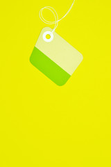 irregular paper tag on yellow background vertical template
