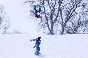People are enjoying downhill skiing and snowboarding	