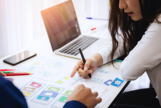 Programmer developing technologies about wireframe application designe of mobile phone. User experience Design concept.