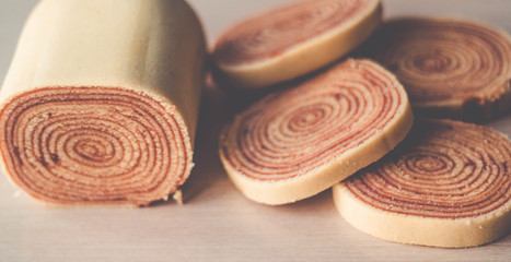 Bolo de rolo (swiss roll, roll cake) Brazilian dessert on white plate on grey background - Recife, Pernambuco, Brazil