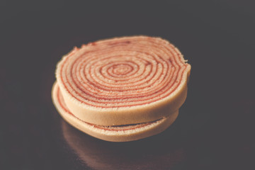 Bolo de rolo (swiss roll, roll cake) Brazilian dessert on black background - Isolated 