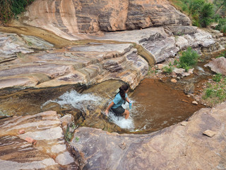 Young woman enjoys some downtime in Hermit Creek during a multi-day backpacking expedition on the Hermit Loop in Grand Canyon National Park, Arizona.