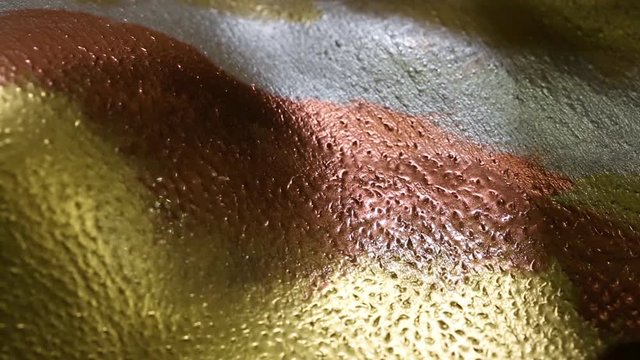 Painting on model’s body with brush. Macro footage of art bodypainting. Shallow focus