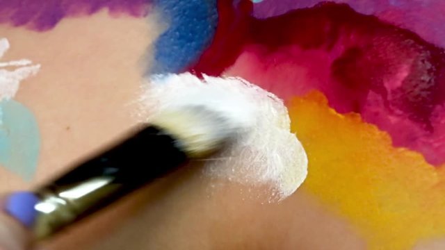 Painting on model’s body with brush. Macro footage of art bodypainting. Shallow focus