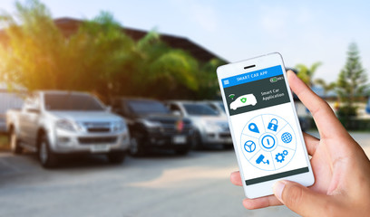 Hand holding smart phone and application dashboard with blur car parking background.