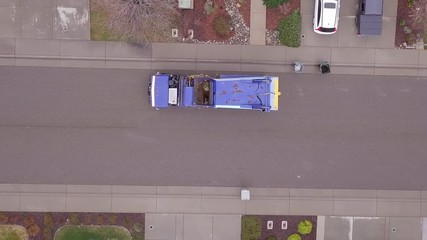 Aerial top down view of garbage truck or dustbin lorry collecting trash.