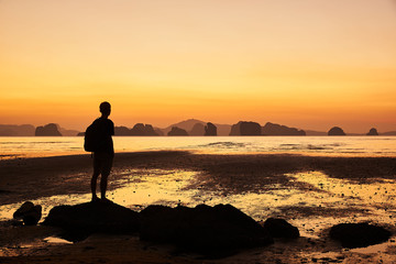Fototapeta premium A man looking at beautiful sunrise in the sea