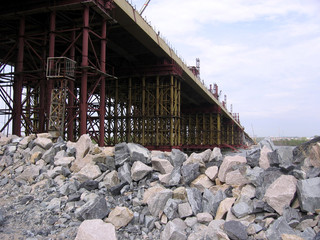 construction Bugrinskij bridge in Novosibirsk on the river Ob a pile of large stones for building construction