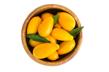 Ripe sweet orange kumquats in wooden bowl