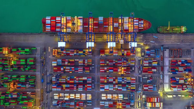 Container cargo freight ship with working crane bridge discharge at container terminal, Aerial top view container ship at deep sea port.