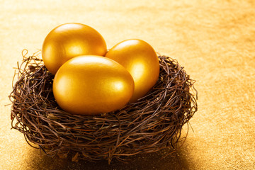 gold eggs on a nest on a golden background