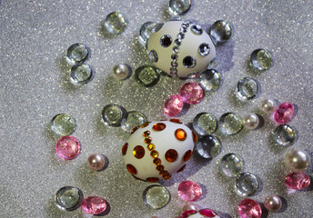 Easter composition flatlay. Easter eggs decorated with shiny rhinestones on  silver background with glass ornaments and pearl beads.