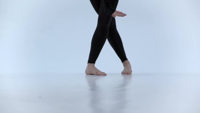 Close up of a dancer's feet as she practices point exercises, slow motion.