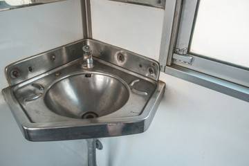 Stainless steel sink in the corner on the train.