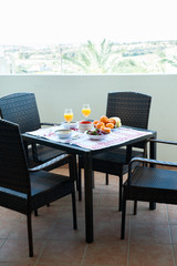 Breakfast on the table, juice, cereal and fruits in the sun. Good food, proper breakfast, strawberries, tangerines, bananas, nuts