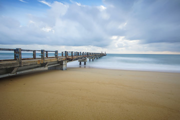 Fototapeta premium Boardwalk on beach at sunrise . Awana Kijal, Kemaman. Malaysia. 