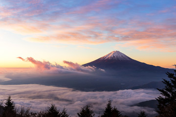 Fototapeta na wymiar Fuji mountain and the mist over Lake Kawaguchiko at beautiful sunrise , Yamanashi, Japan, Mount Fuji or Fujisan located on Honshu Island, is the highest mountain in Japan.