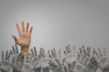 Group of human hands raised high up on grey - Powered by Adobe