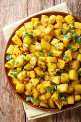 Jeera aloo recipe simple, delicious potatoes sauteed in mild spices close-up on a plate. Vertical top view