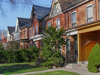 Fototapeta na wymiar street of restored Victorian brick row houses with gables