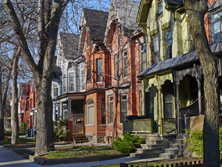 street of restored Victorian brick row houses with gables