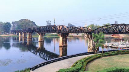 KANCHANABURI, THAILAND - FEBRUARY 17, 2019_Tourists visit The River Kwai Bridge in Kanchanaburi Province. This steel bridge is one of important historical landmarks and memorials in Thailand
