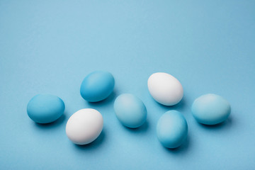 Group ombre blue Easter eggs on colorful background. close up