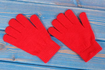 Pair of red womanly gloves for autumn or winter