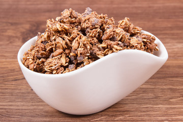 Oat flakes with chocolate in bowl, healthy food for breakfast concept