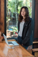 woman using laptop and smartphone in cafe