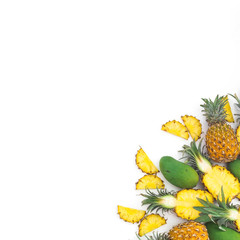 Tropical fruits composition of pineapple and mango fruits on white background. Flat lay, top view.