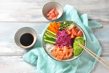 Fresh seafood recipe. Organic food. Fresh salmon poke bowl with crystal noodles, fresh red cabbage, avocado, cherry tomatoes. Food concept poke bowl 