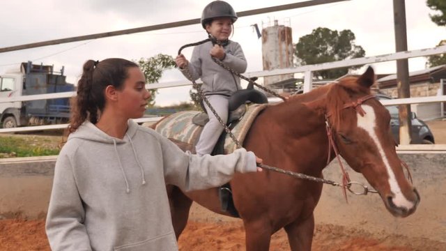 Therapeutic Riding Instructor With Kid