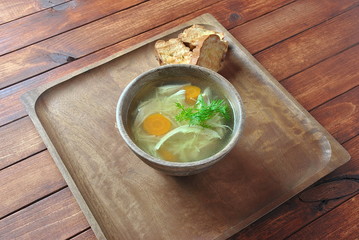 Chicken soup with noodles and vegetables in bowl on wooden background homemade healthy meal