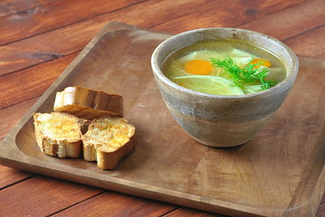 Chicken soup with noodles and vegetables in bowl on wooden background homemade healthy meal