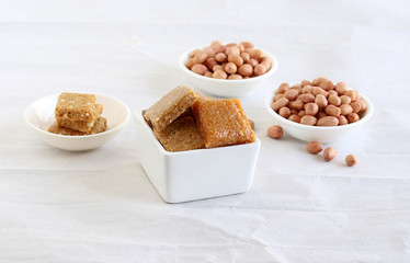 Chikki, an Indian vegetarian, traditional and popular sweet dish, is made from jaggery and peanuts, in bowls.