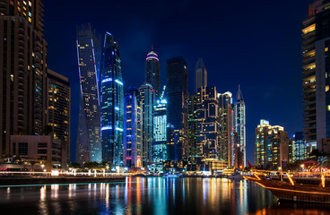 Dubai marina modern skyscrapers and luxury yachts at blue hour