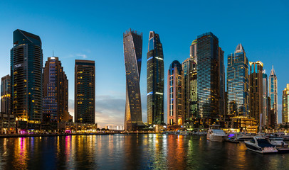 Dubai marina modern skyscrapers and luxury yachts at blue hour